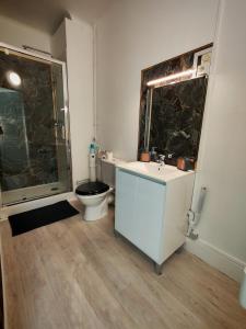 a bathroom with a toilet and a sink and a shower at Perle Centers in Dunkerque