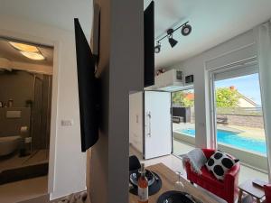 a kitchen and living room with a view of a pool at Studio Claudia in Opatija