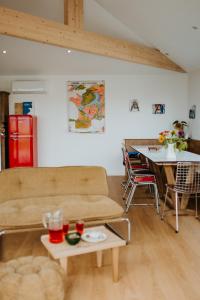 a living room with a couch and a table at Les Ecuries du bout du monde in Landunvez