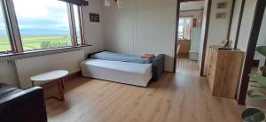 a small room with a bed and a window at Guesthouse Klambrasel in Skogar +16 photos