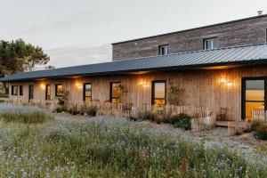 a house with a garden in front of it at Les Ecuries du bout du monde in Landunvez