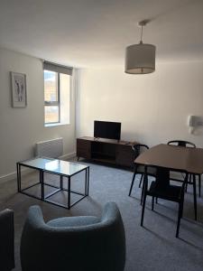 a living room with a table and chairs and a couch at 505 Broadway residence in Bradford