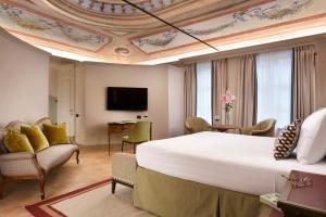 a hotel room with a large bed and a tv at Relais Sant'Uffizio in Cioccaro +82 photos