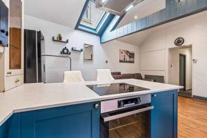 a kitchen with a blue island with a counter top at Group-Friendly, Sheffield Flat, sleeps 6 in Walkly