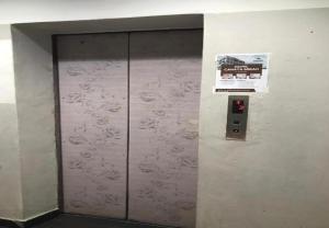a metal elevator door with a sign on it at Cahaya Midah Hotel (BilikXpert) in Kuala Lumpur +24 photos