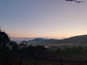 a view of a valley with mountains in the distance at Ethlathini Rest Camp in Hluhluwe