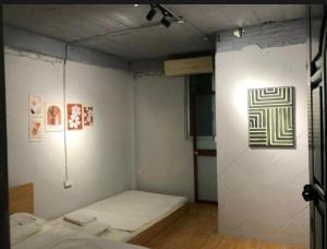 a room with a bed and a wall with a picture at Hanoi Harmony in Hanoi