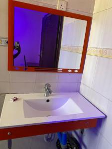 a white sink in a bathroom with a mirror at New Gold city hotel in Mwanza