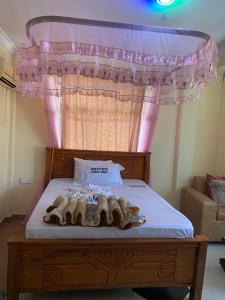 a bedroom with a bed with a canopy at New Gold city hotel in Mwanza