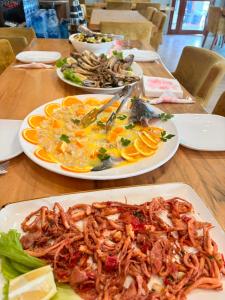 two plates of food on a wooden table at Hotel Bar Restaurant Riviera in Shëngjin
