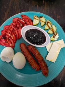 a blue plate of food with sausage and other foods at Hotel Bar Restaurant Riviera in Shëngjin +36 photos