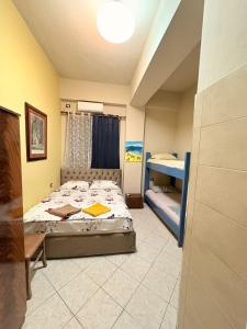 a bedroom with a bed and a desk in it at Hotel Bar Restaurant Riviera in Shëngjin
