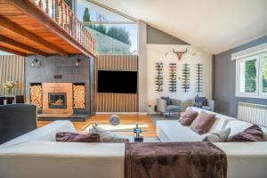 a living room with a couch and a fireplace at Villa Romeo in Oviedo