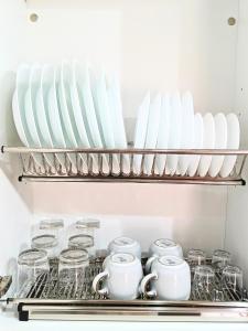 a shelf in a kitchen with dishes and cups at Cozy & Terrace Apartament5 in Los Cristianos +9 photos