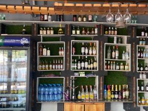 a shelf filled with lots of bottles of alcohol at New Gold city hotel in Mwanza