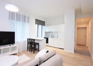 a living room with a couch and a kitchen at Otepää Residence in Otepää