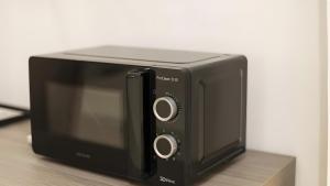 a black toaster oven sitting on top of a counter at Vie Del Salento in San Pancrazio Salentino