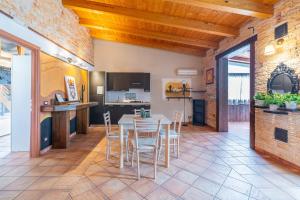 a kitchen and dining room with a table and chairs at Pathos Retreat Pool and Garden in Syracuse
