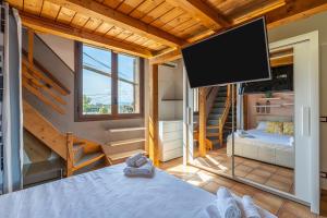 a room with a bed and a flat screen tv at Pathos Retreat Pool and Garden in Syracuse +127 photos