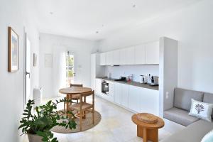 a kitchen and living room with a couch and a table at Theros Apartments 3 in Mylopotas