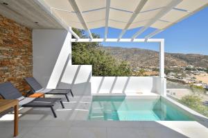 a house with a swimming pool with a view at Theros Apartments 3 in Mylopotas