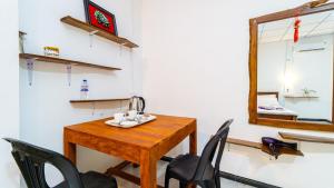 a room with a table and chairs and a mirror at N S K Green Villa in Sigiriya +60 photos