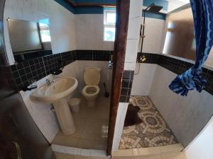a small bathroom with a toilet and a sink at jc iten in Iten +30 photos