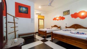 a room with two beds and a ladder in it at N S K Green Villa in Sigiriya