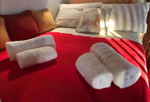 a bed with two rolled up towels on it at Luxury Maisonet Veranda View Batsi in Batsi