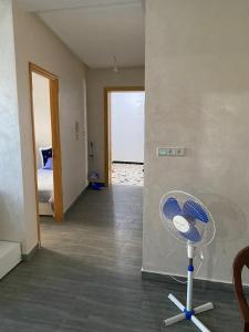 a room with a fan and a room with a bedroom at Appartement 1 in Al Hoceïma +1 photo