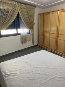 a bedroom with a large bed and a window at Appartement 1 in Al Hoceïma