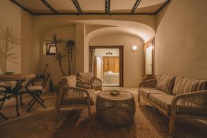 a living room with a couch and a table at Hotiday Elite Olea Sanctuary in Olbia