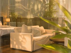 a living room with a couch and a bed at Amana Boutique Riverside - An Khanh in Ho Chi Minh City