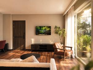 a living room with a couch and a chair at Amana Boutique Riverside - An Khanh in Ho Chi Minh City