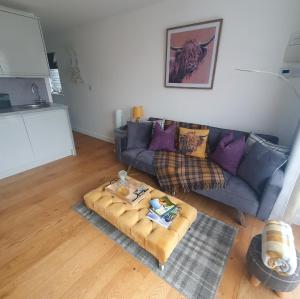 a living room with a couch and a coffee table at The Nook in Inverness