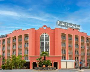 a hotel with a red building with a sign on it at Hotel Las Águilas Tenerife, Affiliated by Meliá in Puerto de la Cruz +51 photos