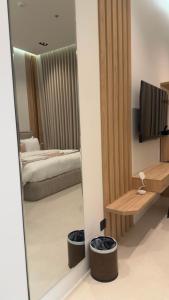 a mirror in a room with a bed and a bedroom at Tim in Riyadh
