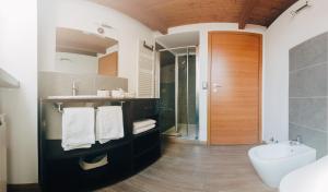 a bathroom with a sink and a toilet and a tub at PICCOLA VILLA nel Centro Storico in Arona +51 photos