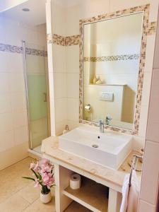 a bathroom with a sink and a mirror at Wellness-Oase-Nossen Kirchblick in Nossen +11 photos