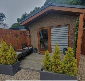 a house with a wooden deck with a garage at The Nook in Inverness