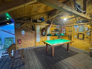 a ping pong table in a room in a cabin at Luxdomki in Krasnobród