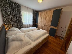 a bedroom with two beds and a window at Ferienwohnung Stern, Natters in Innsbruck