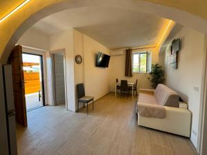 a living room with a couch and a table at QUEEN appartamenti e camere in Campofilone