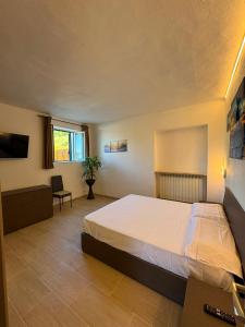 a bedroom with a large bed in a room at QUEEN appartamenti e camere in Campofilone +52 photos