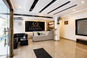 a lobby with a black and white sign on the wall at Hotel Tamanna 2 Minute Walk from Golden Temple in Amritsar