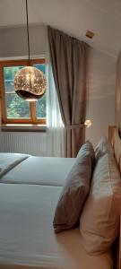 a bedroom with a bed with a pillow and a window at Traumplatz im Allgäu in Rettenberg