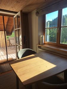 a table and chairs in a room with a window at Traumplatz im Allgäu in Rettenberg +25 photos