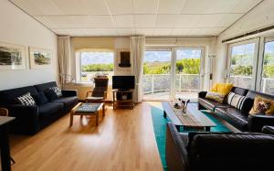 a living room with a couch and a table at De Strandloper in Julianadorp