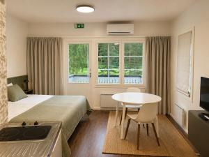 a hotel room with a bed and a table and a window at Aldeia Bianca Lake Resort & Italian Restaurant in Kerimäki