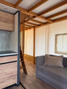 a living room with a couch and a tv at Luna Glamping de Luxe in Drage